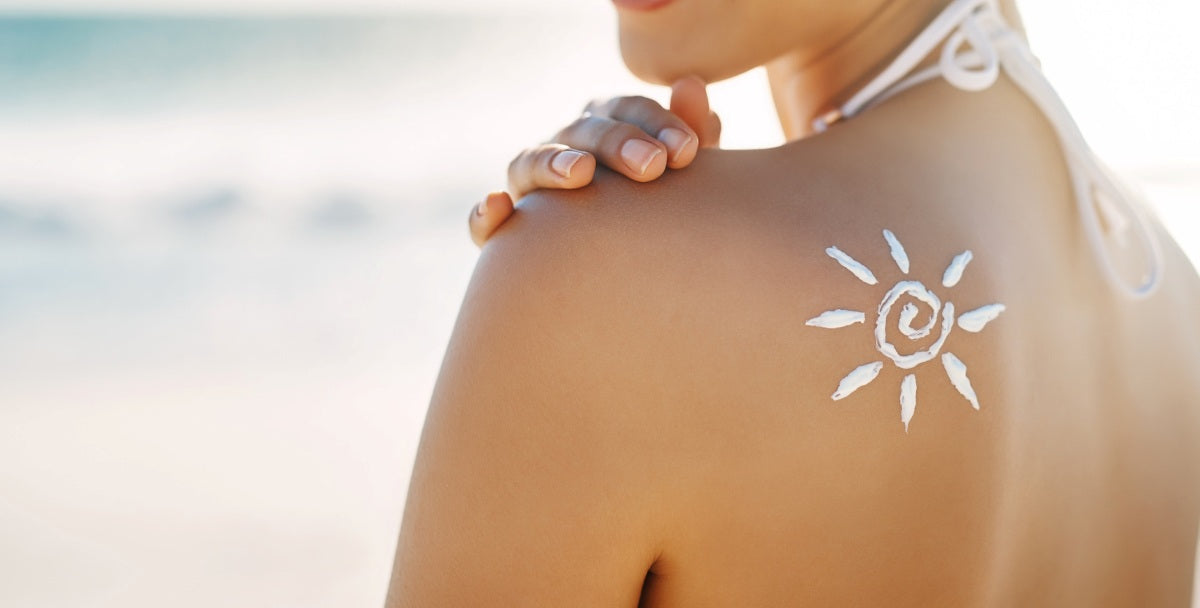 Woman, sun or lotion on shoulder at beach for skincare, protection or healthy skin on vacation